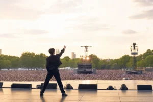 Editorial image of a K-pop soloist performing on a large outdoor London festival stage