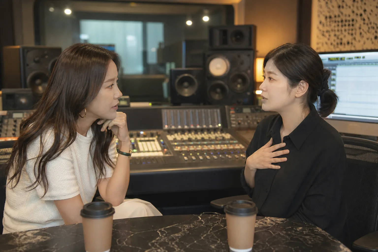 Korean singer reflecting in a recording studio after a personal announcement
