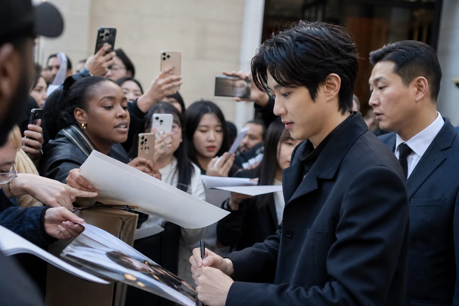Fans waiting outside a Paris fashion event for Korean actor Choi Woo Shik