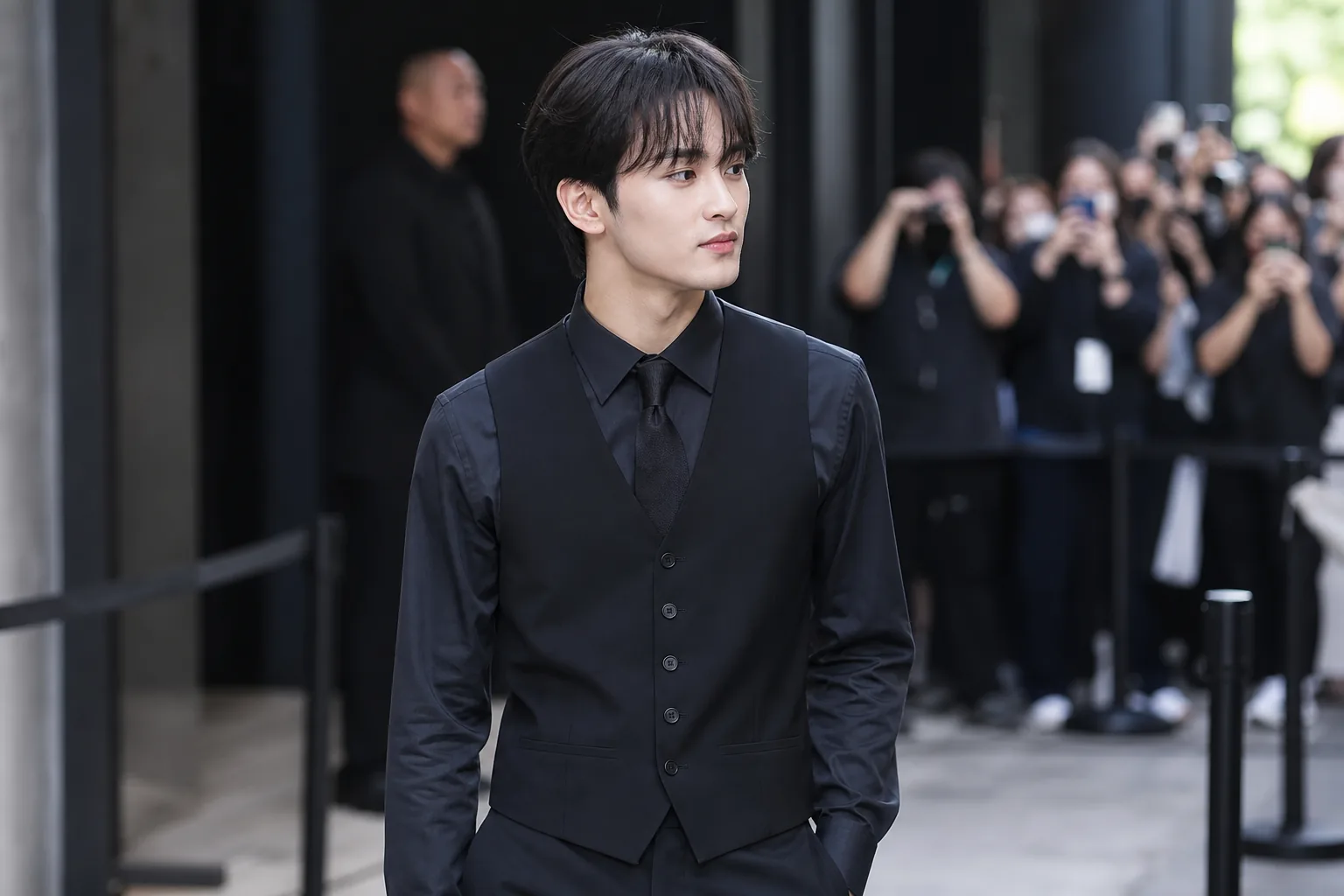Formal blue and white event styling at a K-pop promotional appearance