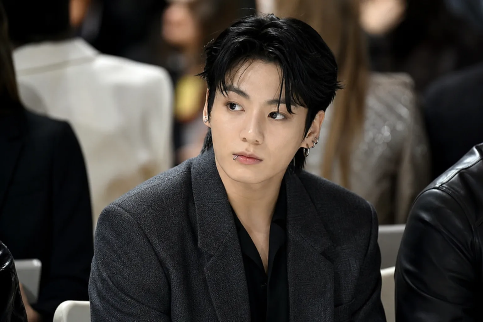 Crowded fashion week venue illustrating the public pressure around BTS Jungkook