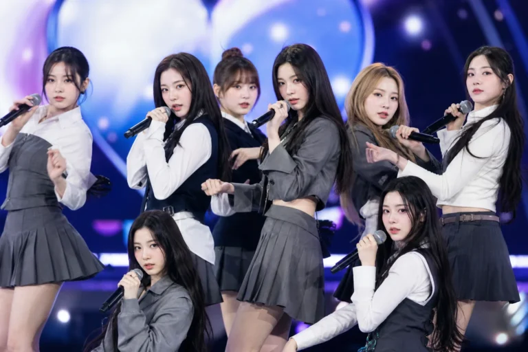 K-pop stage performance representing Hearts2Hearts lip-syncing debate at Busan festival