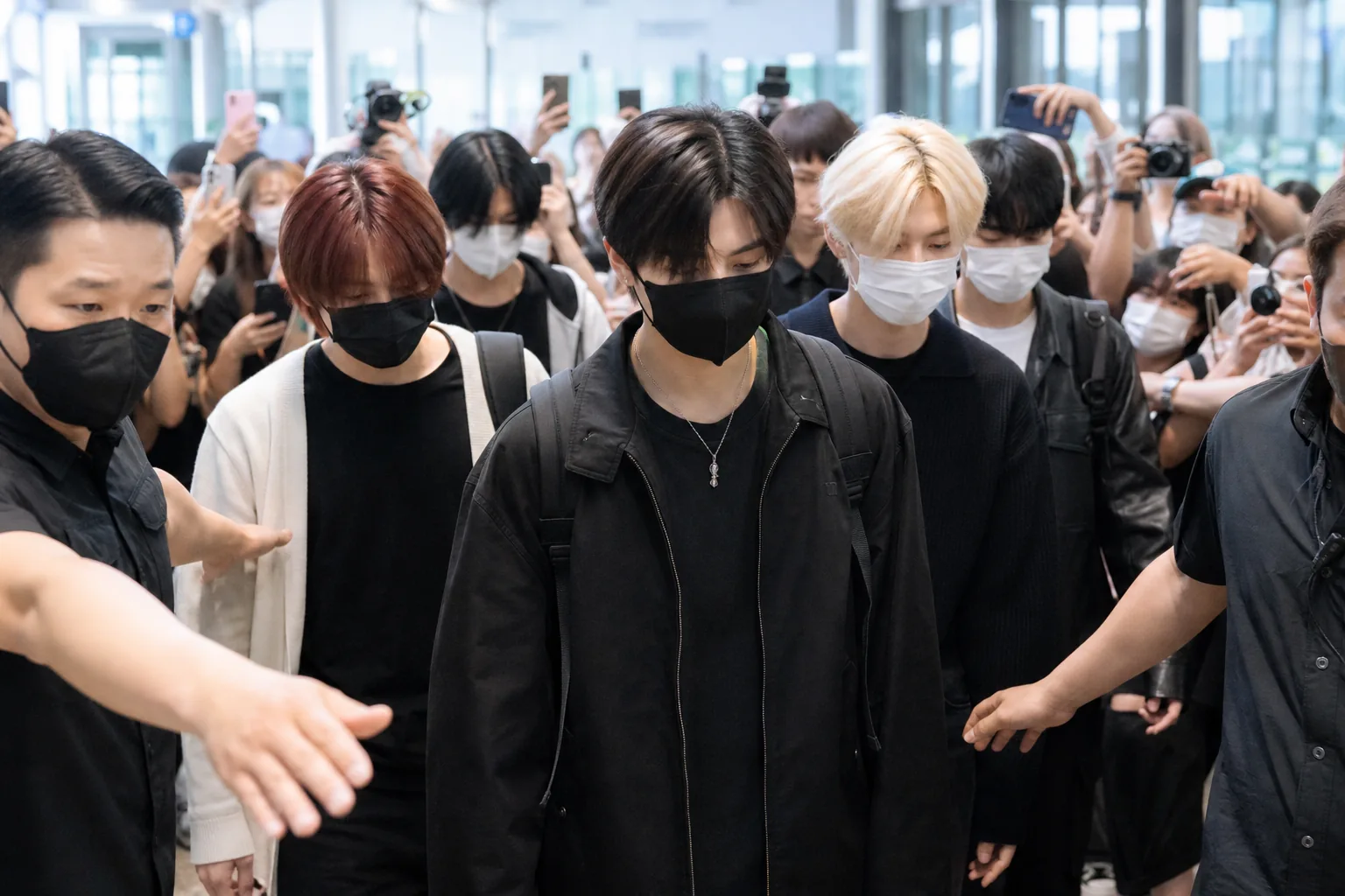 Airport security scene representing privacy boundaries for K-pop artists