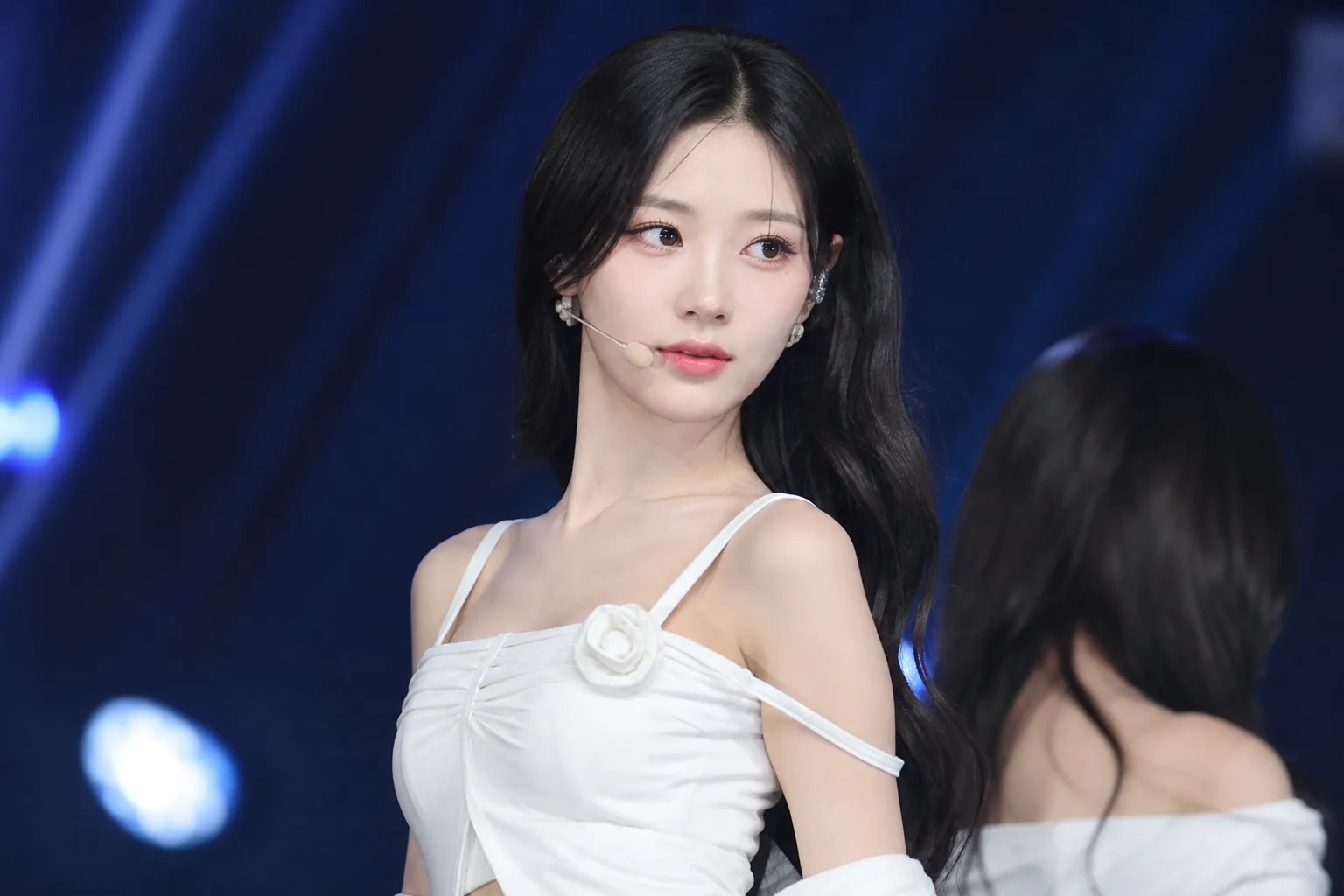 Quiet K-pop performance stage representing YuBin's health-related activity pause