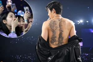 BTS concert stage atmosphere with fans reacting to RM tattoo speculation