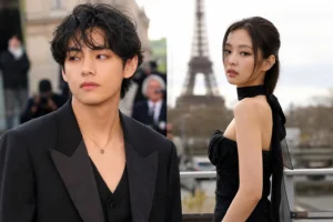 Paris fashion week crowd and cameras representing BTS V and BLACKPINK Jennie dating rumor discussion