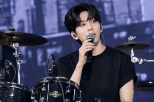 Editorial image of a modern K-pop concert stage representing DAY6 Dowoon fan remarks