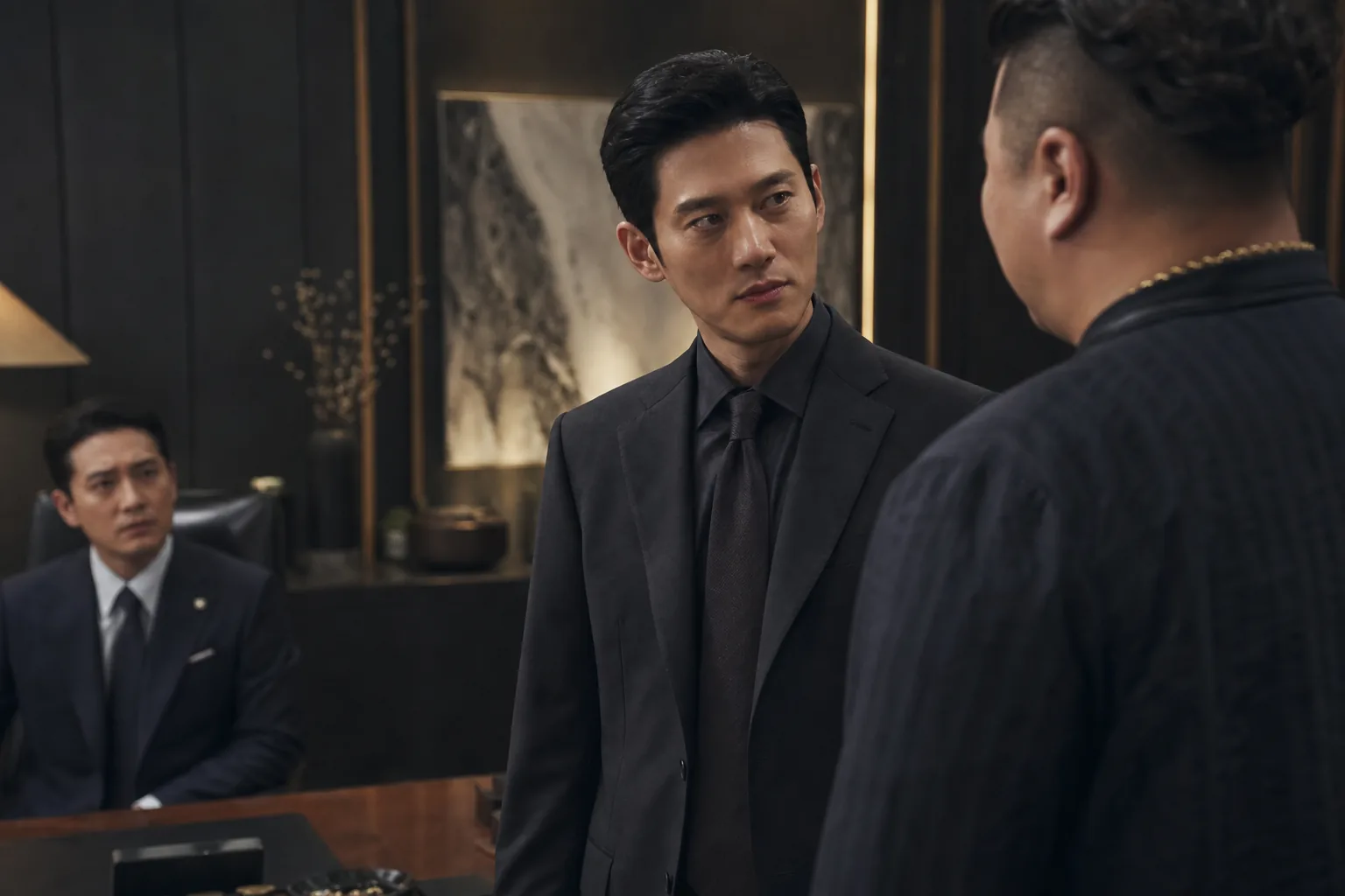 K-drama villain character in a tense office scene