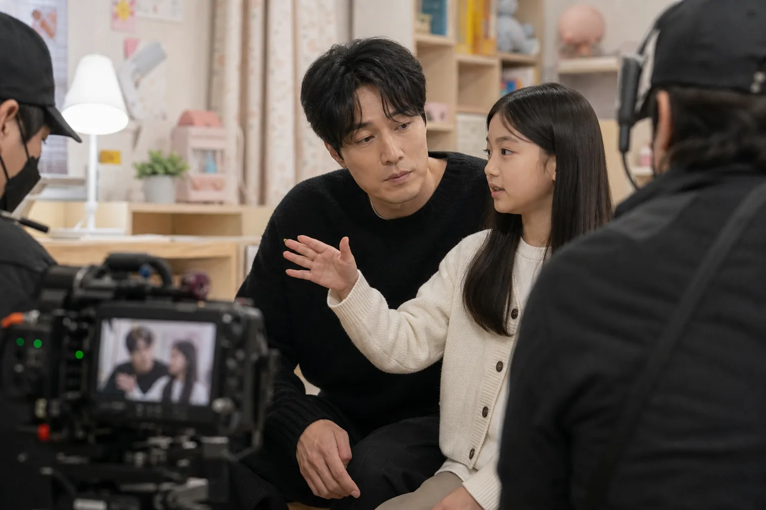 Behind-the-scenes Korean drama set showing cast teamwork and rehearsal energy