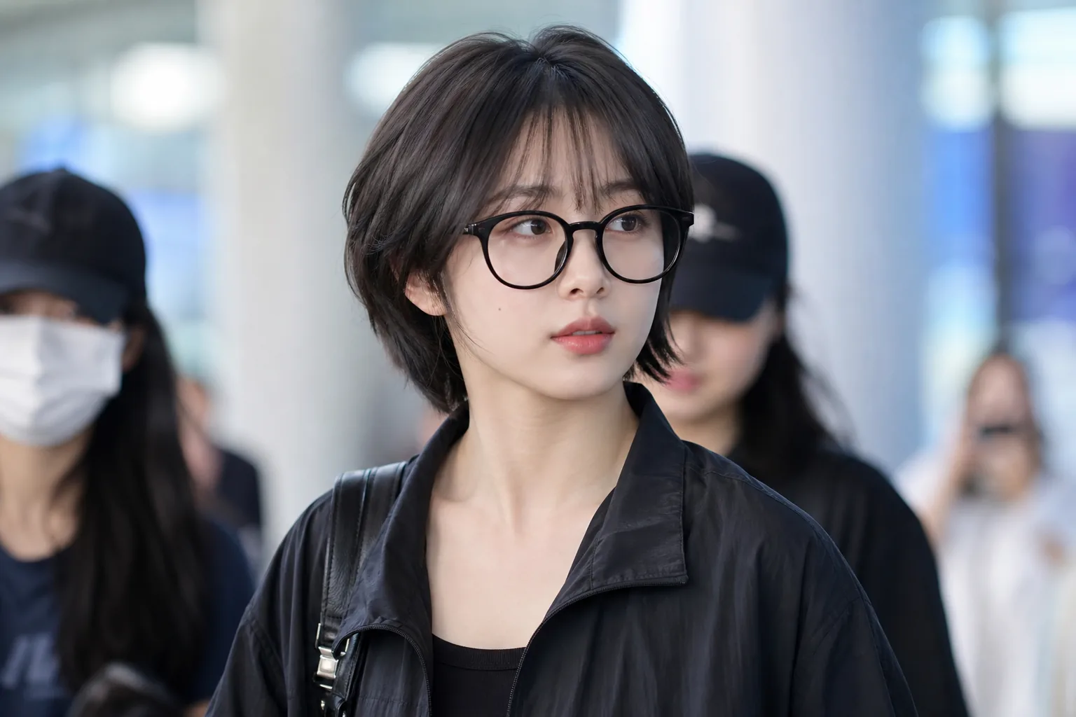 K-pop idol airport fashion with dramatic short hairstyle