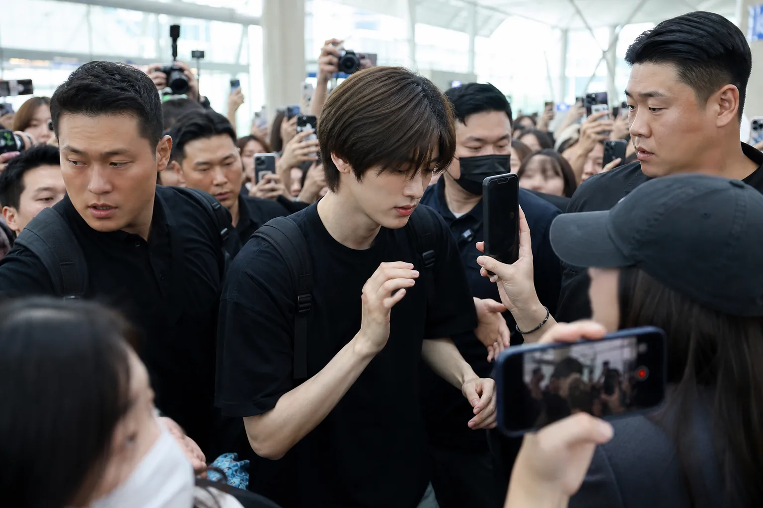 AI editorial image of a crowded airport walkway during a K-pop departure