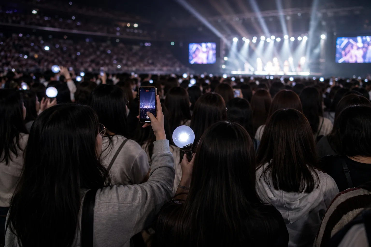 K-pop concert audience discussing fan etiquette and artist respect