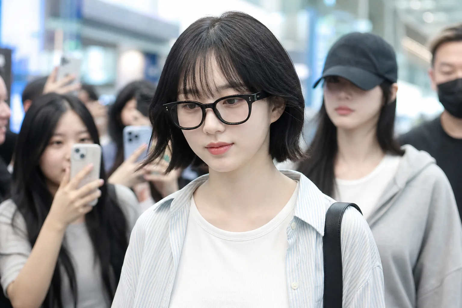 Airport fashion scene symbolizing Haewon's short haircut reveal before NMIXX tour travel