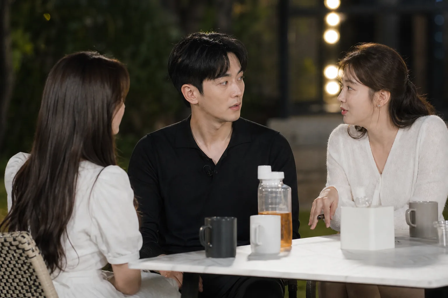 Three reality dating show participants seated during a tense conversation