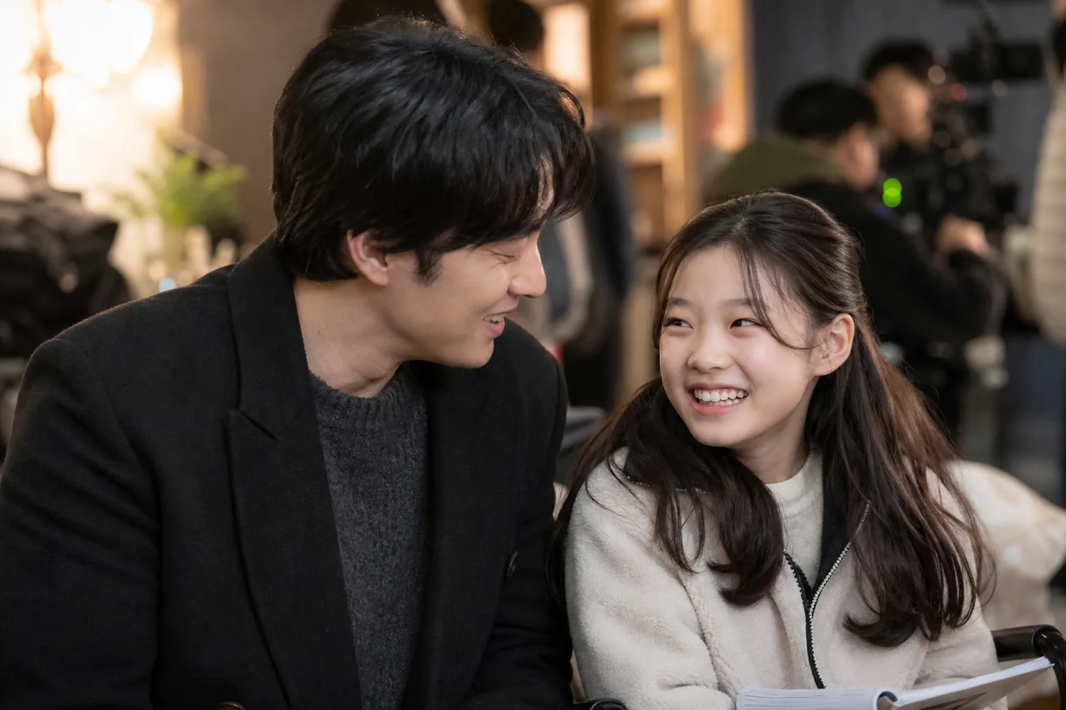 Korean drama actors rehearsing on a modern television production set