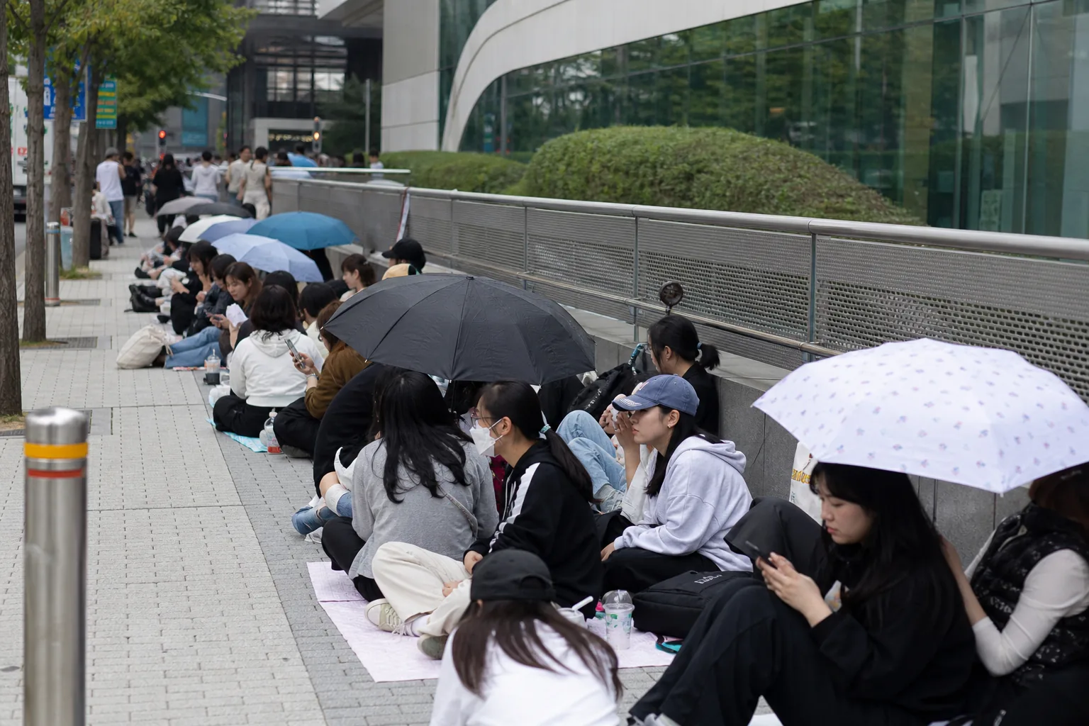 Event staff managing a busy fan queue at a public promotional appearance
