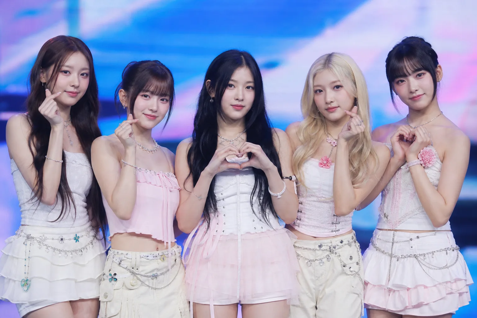 K-pop fans viewing streaming data and social media clips during a small agency breakthrough