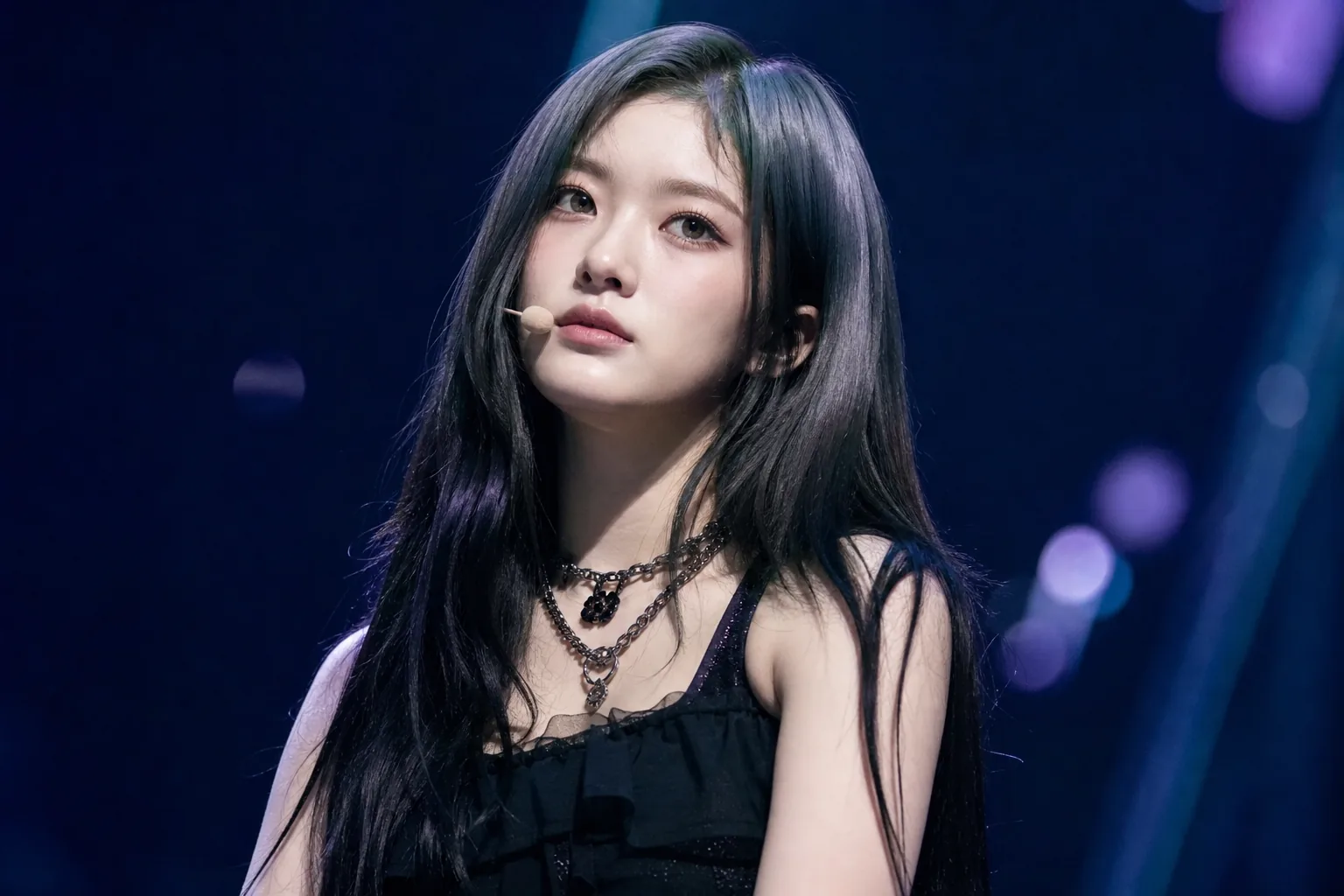 K-pop performer preparing backstage under soft lights