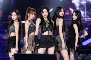 K-pop stage lights symbolizing RESCENE's chart rebound and small-agency competition