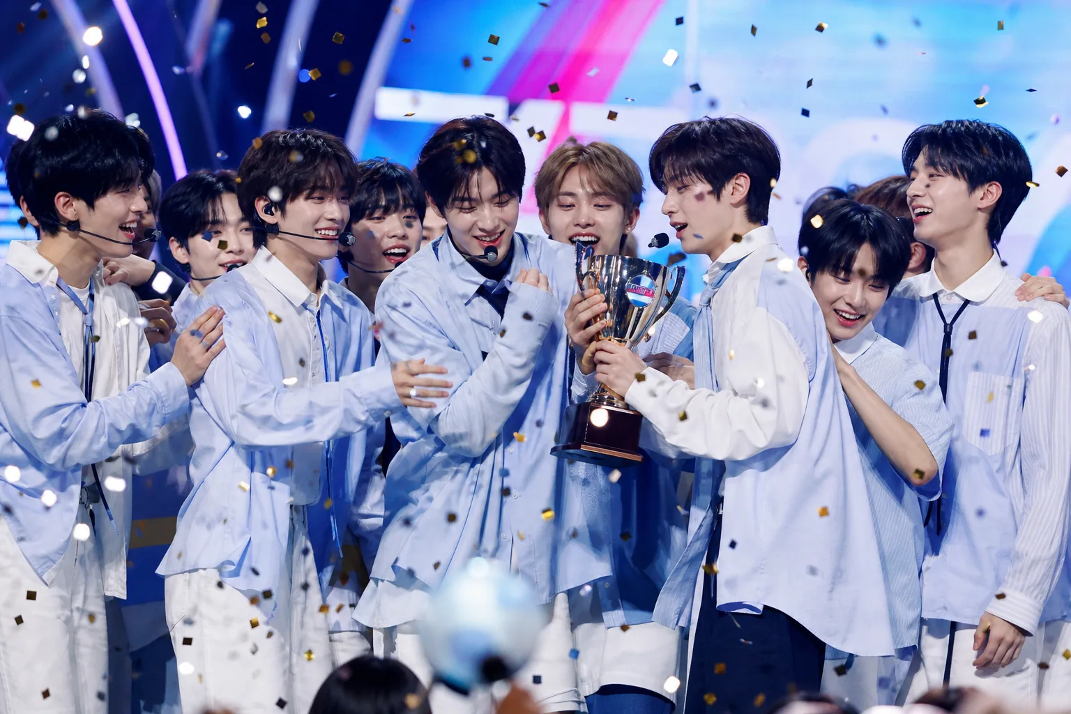 K-pop music show stage with rookie group momentum