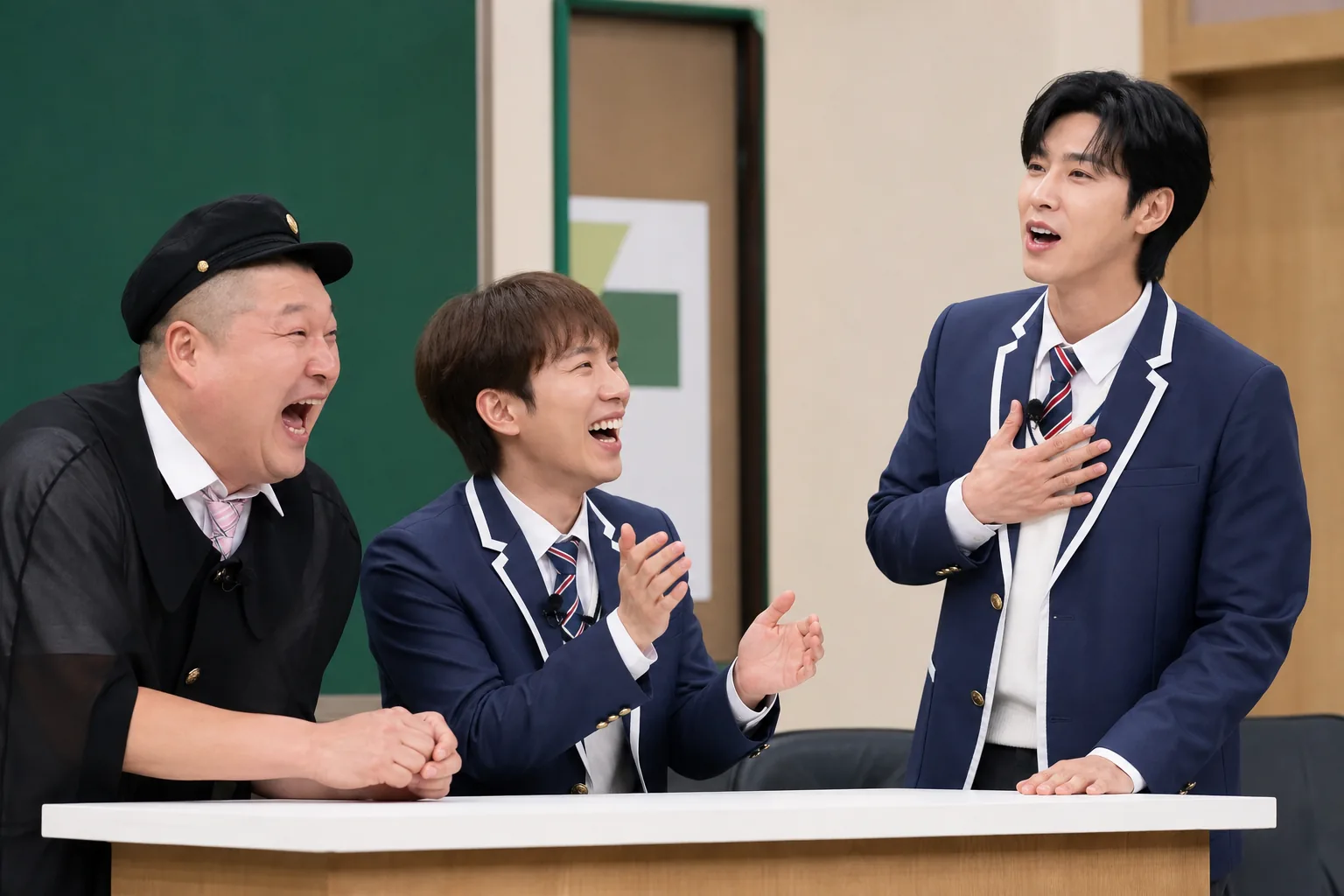 K-pop variety show studio with idol leaders discussing teamwork