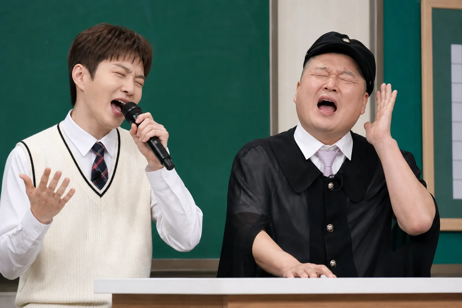 Generations of K-pop leaders represented in a modern broadcast studio