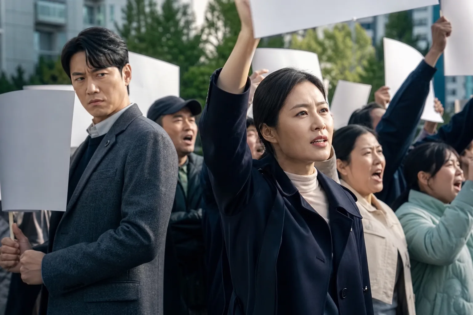 Ji Sung and Moon So Ri characters join residents during an apartment complex protest