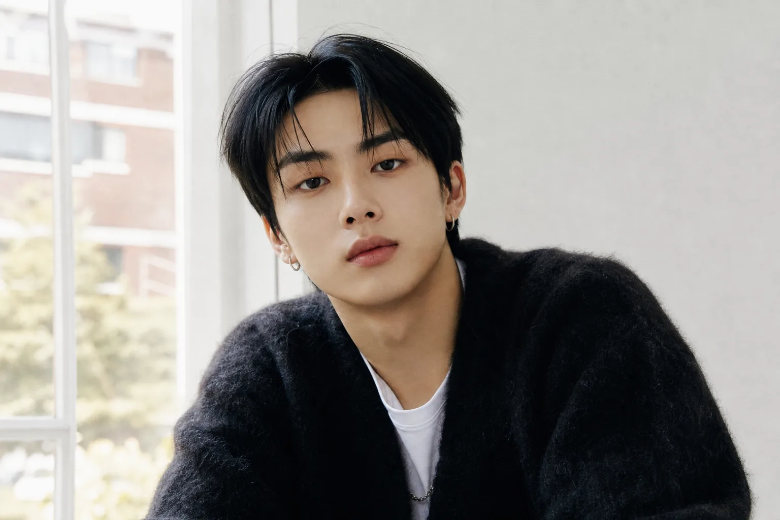 K-pop performer under a stage spotlight representing Brad's transition from idol group member to solo artist