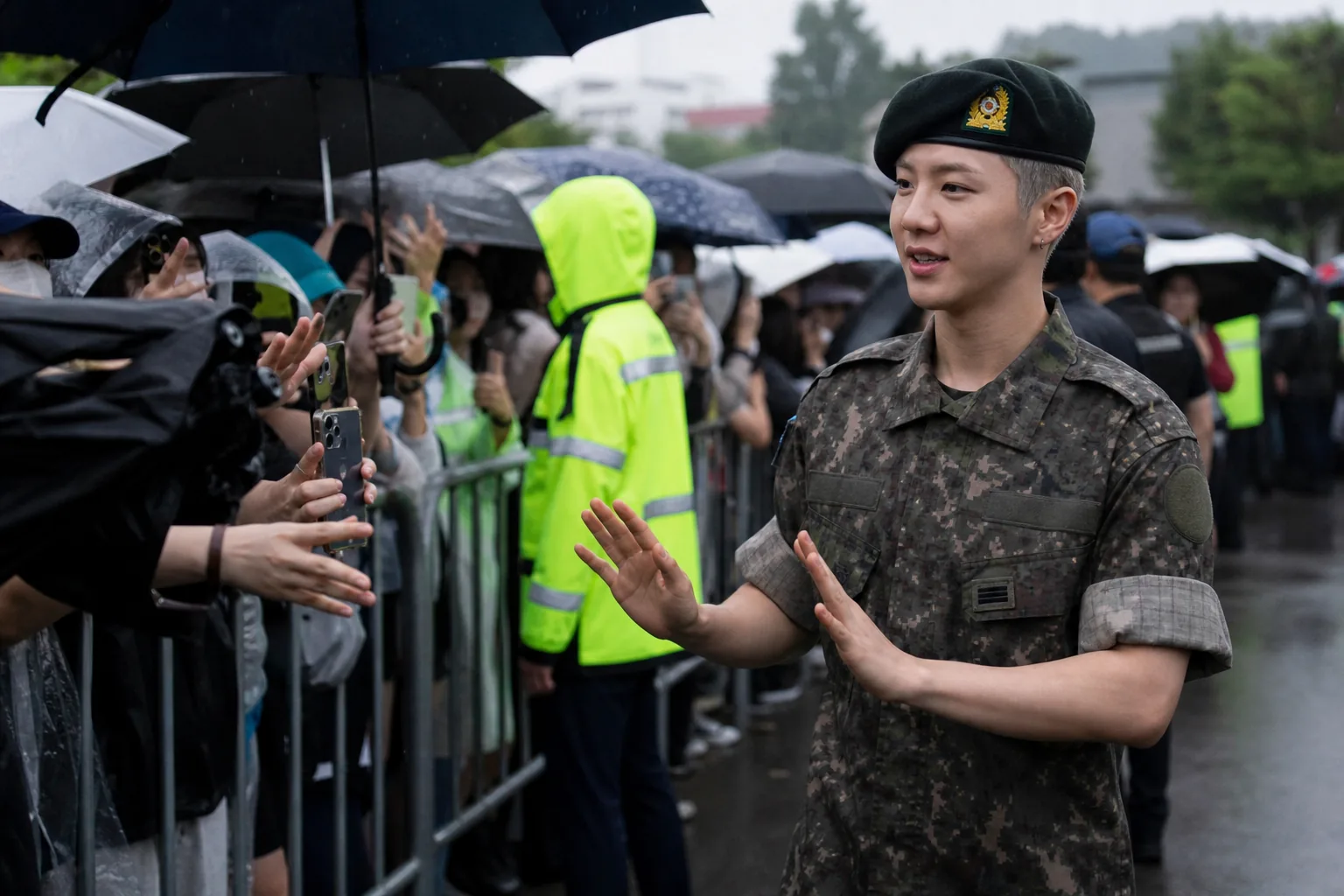 Fans waiting outside a rainy military event venue after attendance restrictions