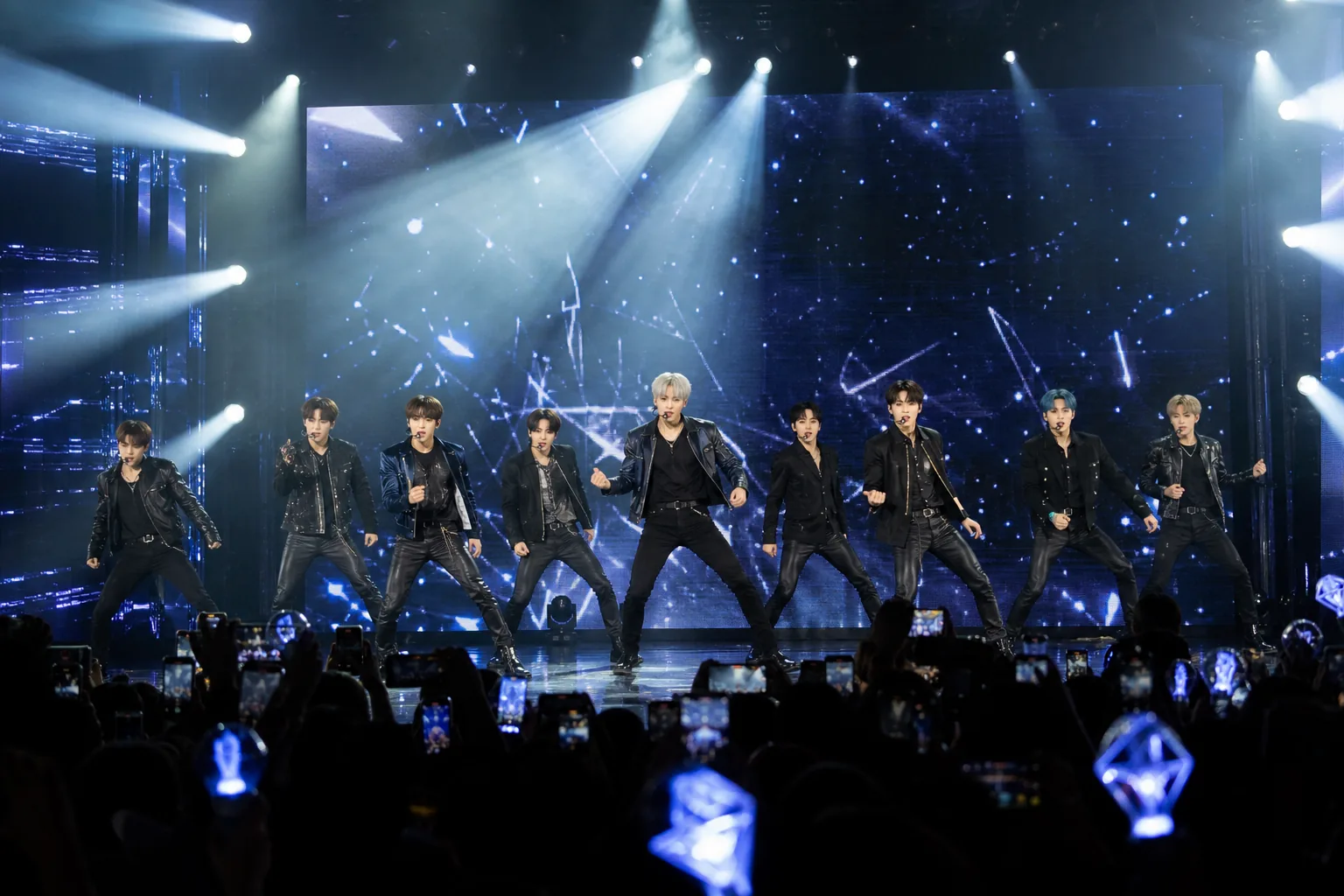 K-pop group anniversary comeback planning with stage lights and fans