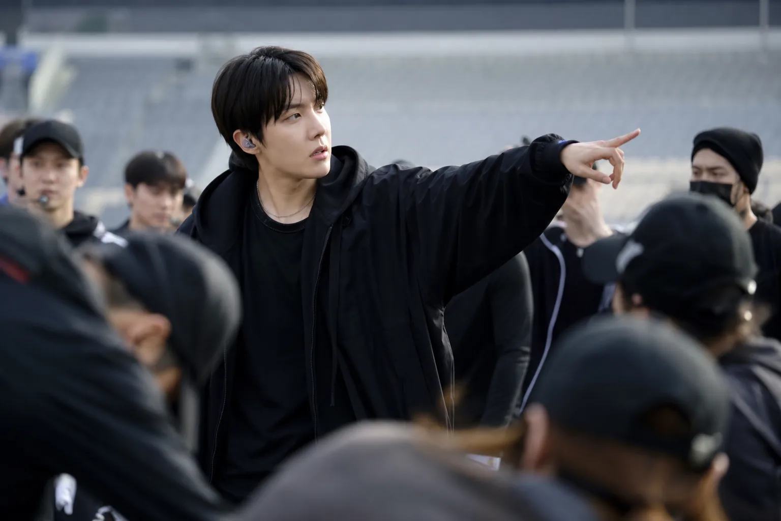 K-pop stage rehearsal showing focused choreography direction