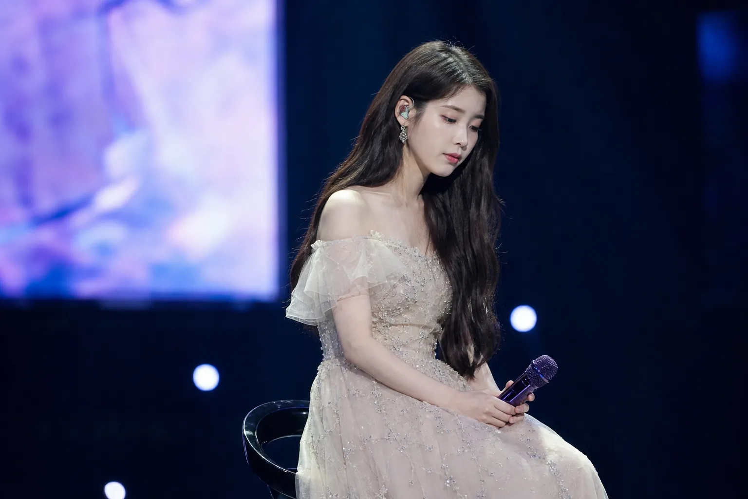 Quiet recording studio representing IU delaying album preparations while recovering