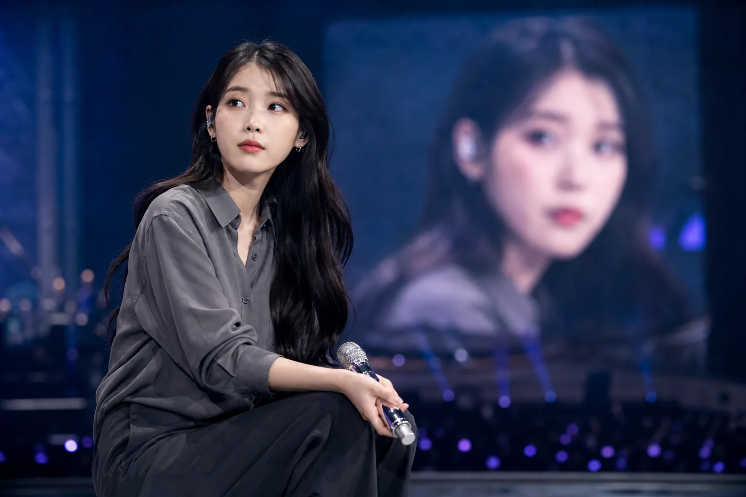 Microphone and stage monitors symbolizing IU's postponed concert due to an ear condition
