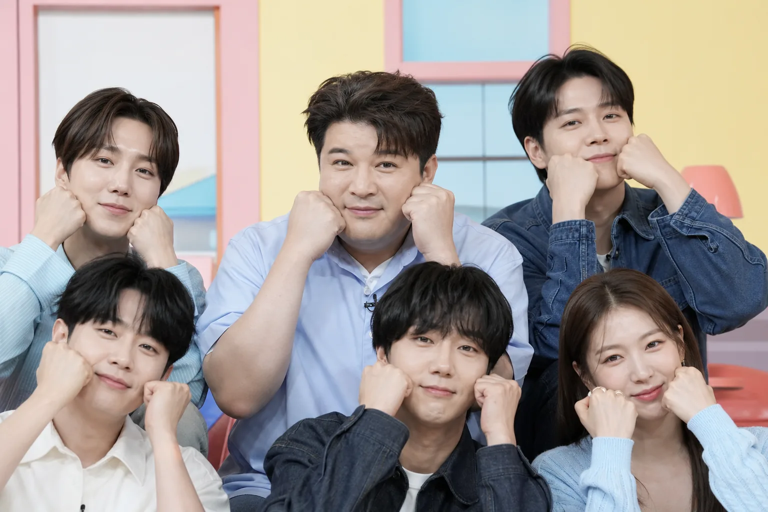 Korean variety show cast posing during a promotional shoot