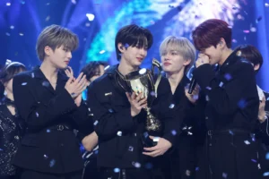 K-pop stage lights representing idntt first Show Champion win for Kids Return