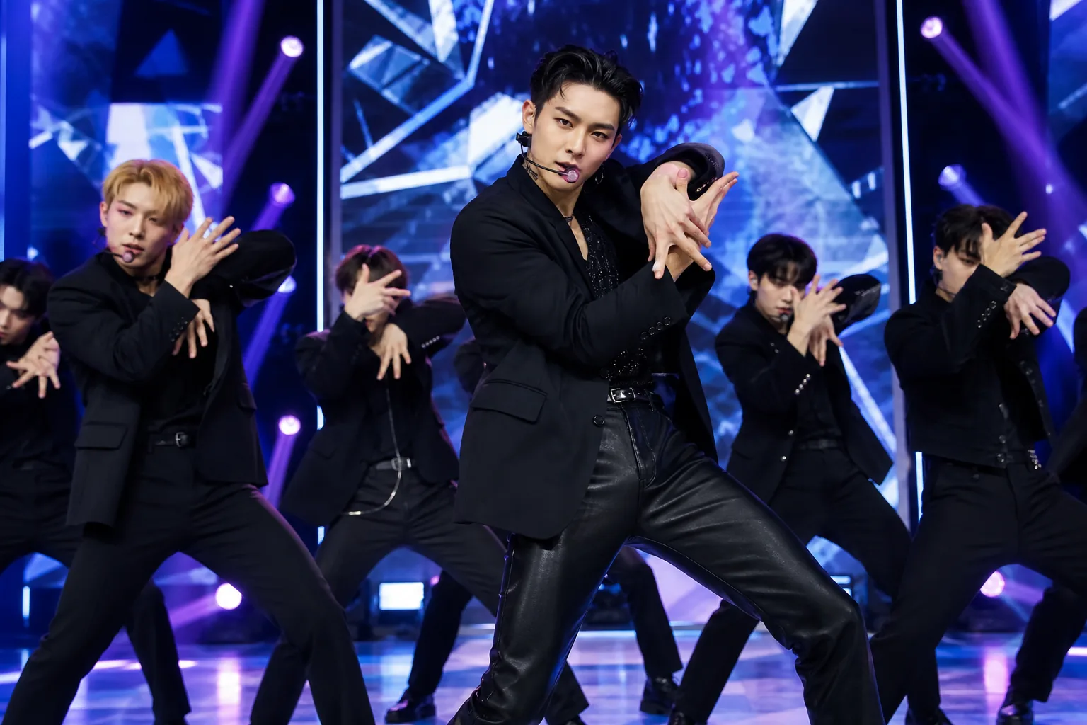K-pop artists preparing backstage before a televised comeback performance
