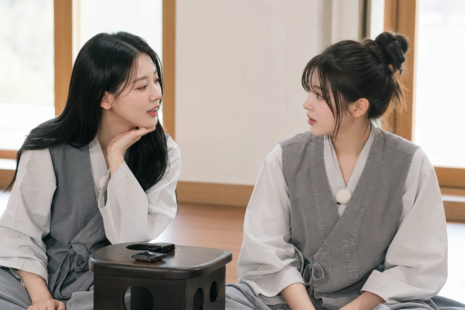 AI editorial image of a young K-pop idol receiving supportive mentoring during a quiet retreat