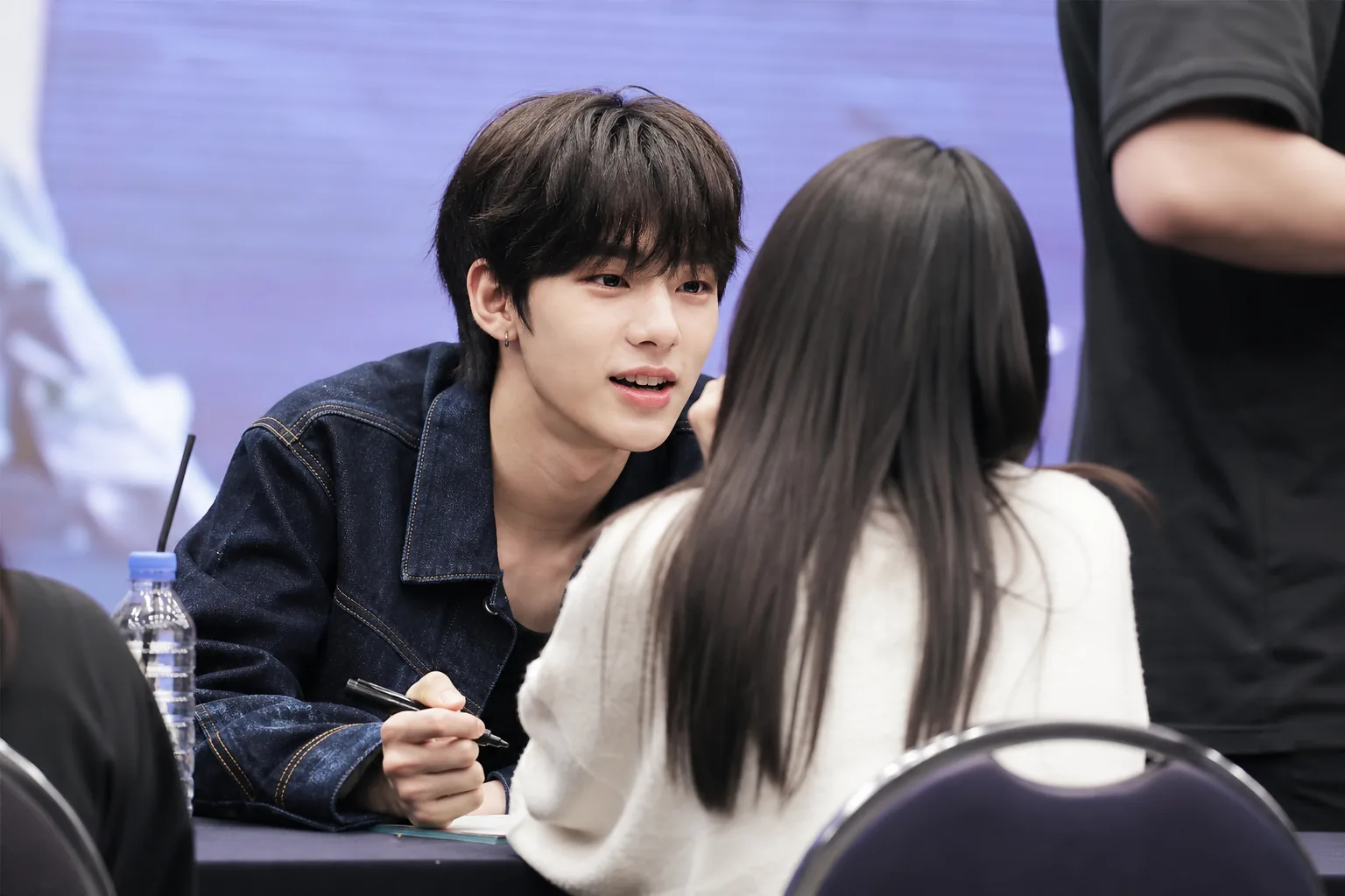 Fans recording a K-pop fansign interaction