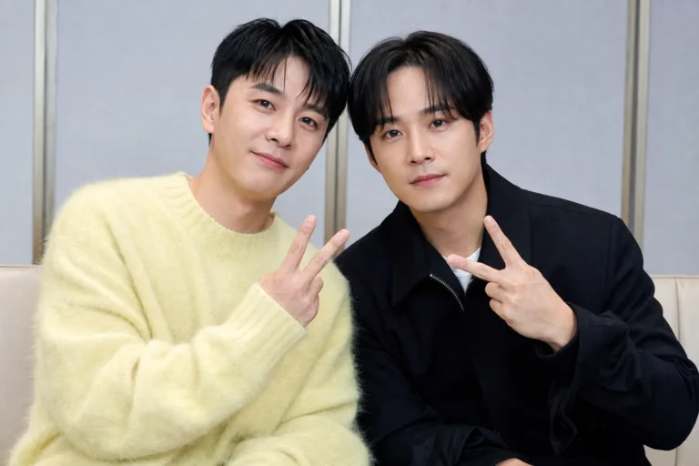 Two former K-pop idols meeting over dinner in a warm restaurant setting