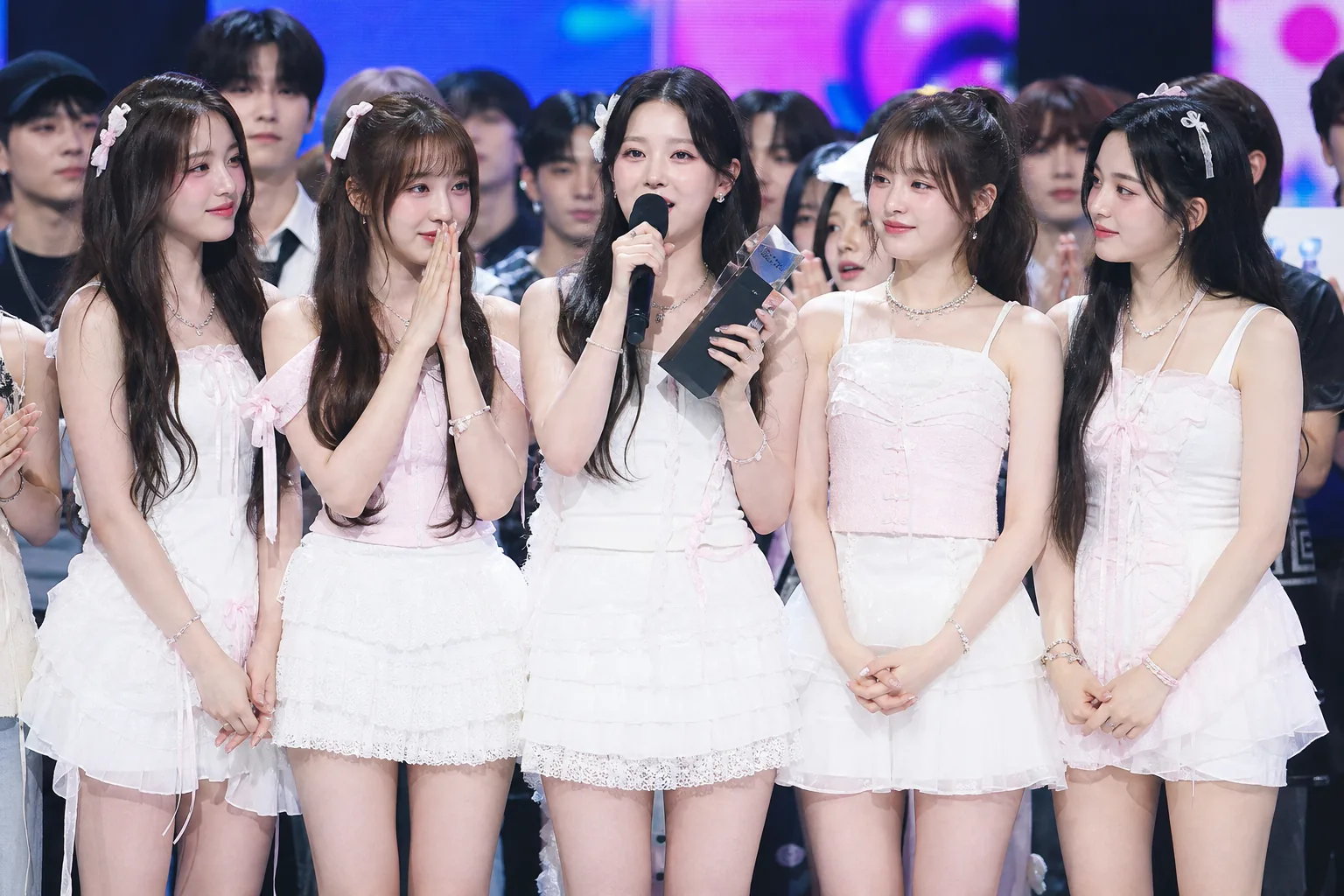 Modern Korean music program stage showing performers during a weekly K-pop broadcast