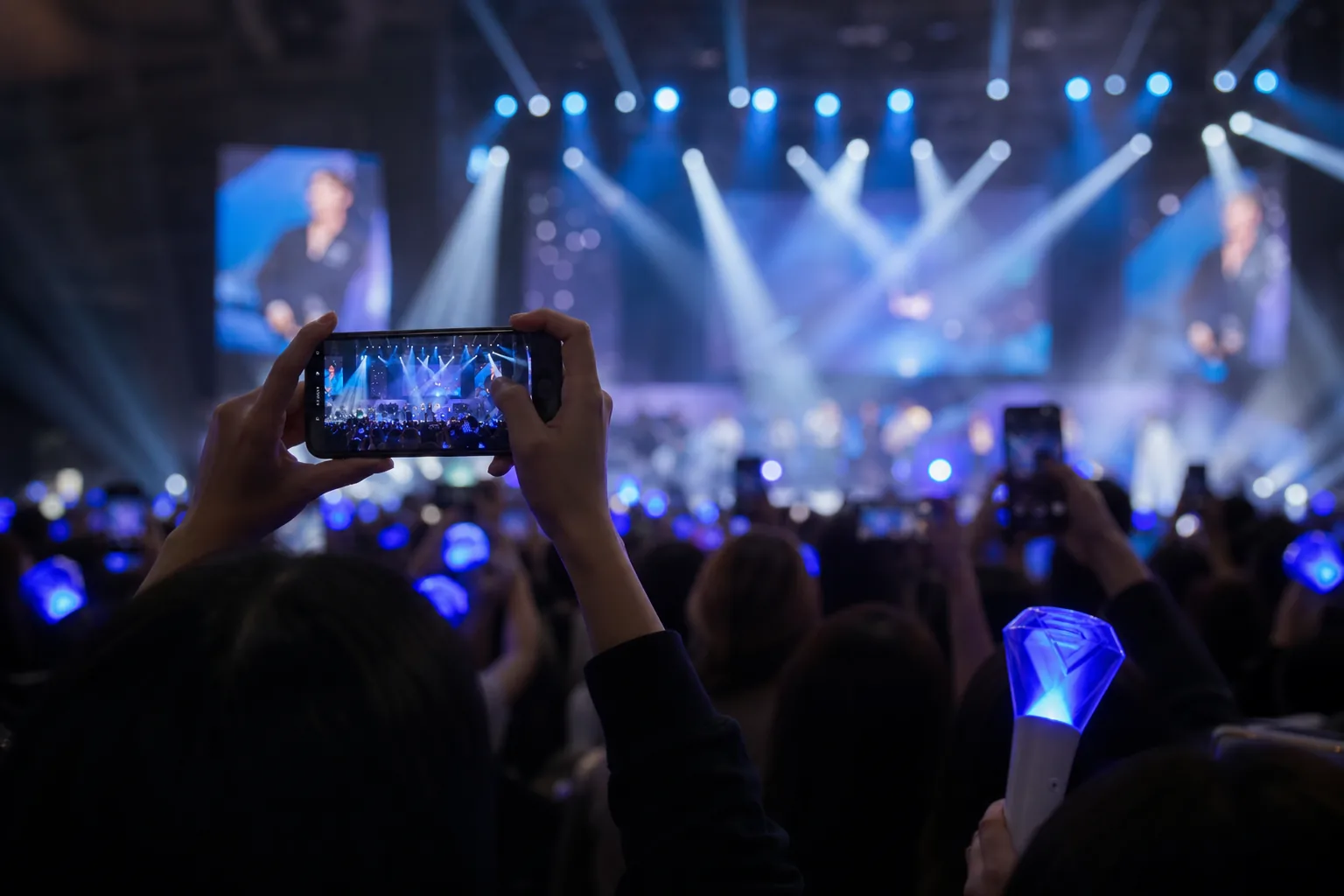 Fans watching a K-pop concert while online discussion spreads about idol dating boundaries