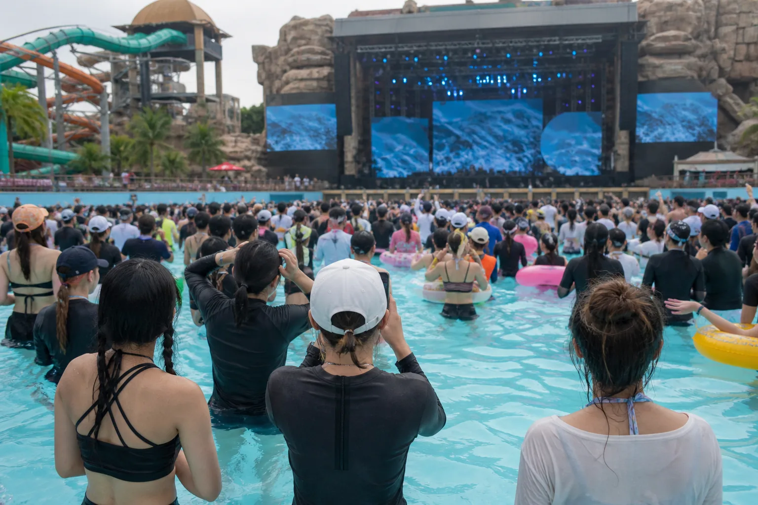 Fans gathered near a water park stage during a summer K-pop event