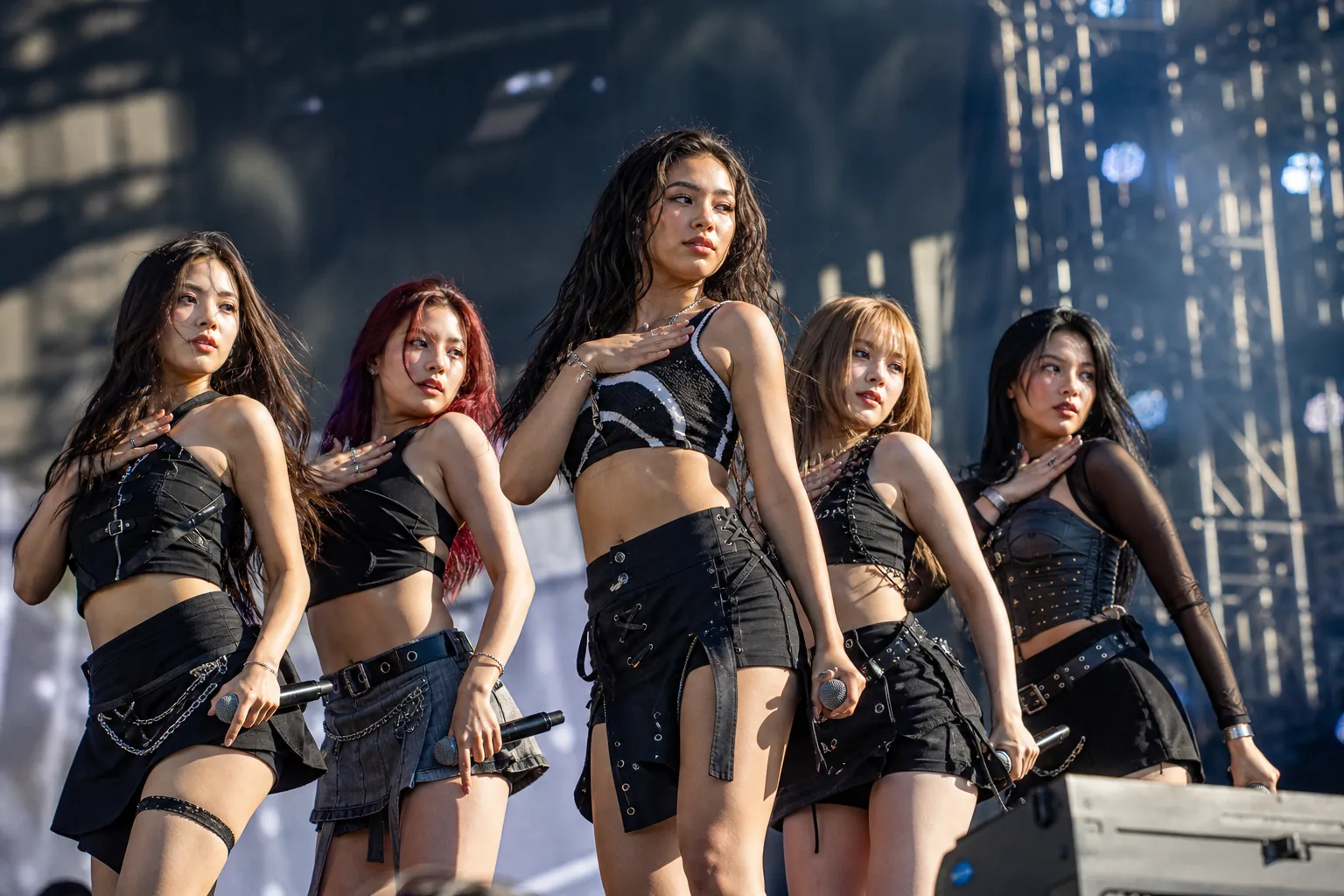 Music festival audience and stage lights during a K-pop performance schedule change