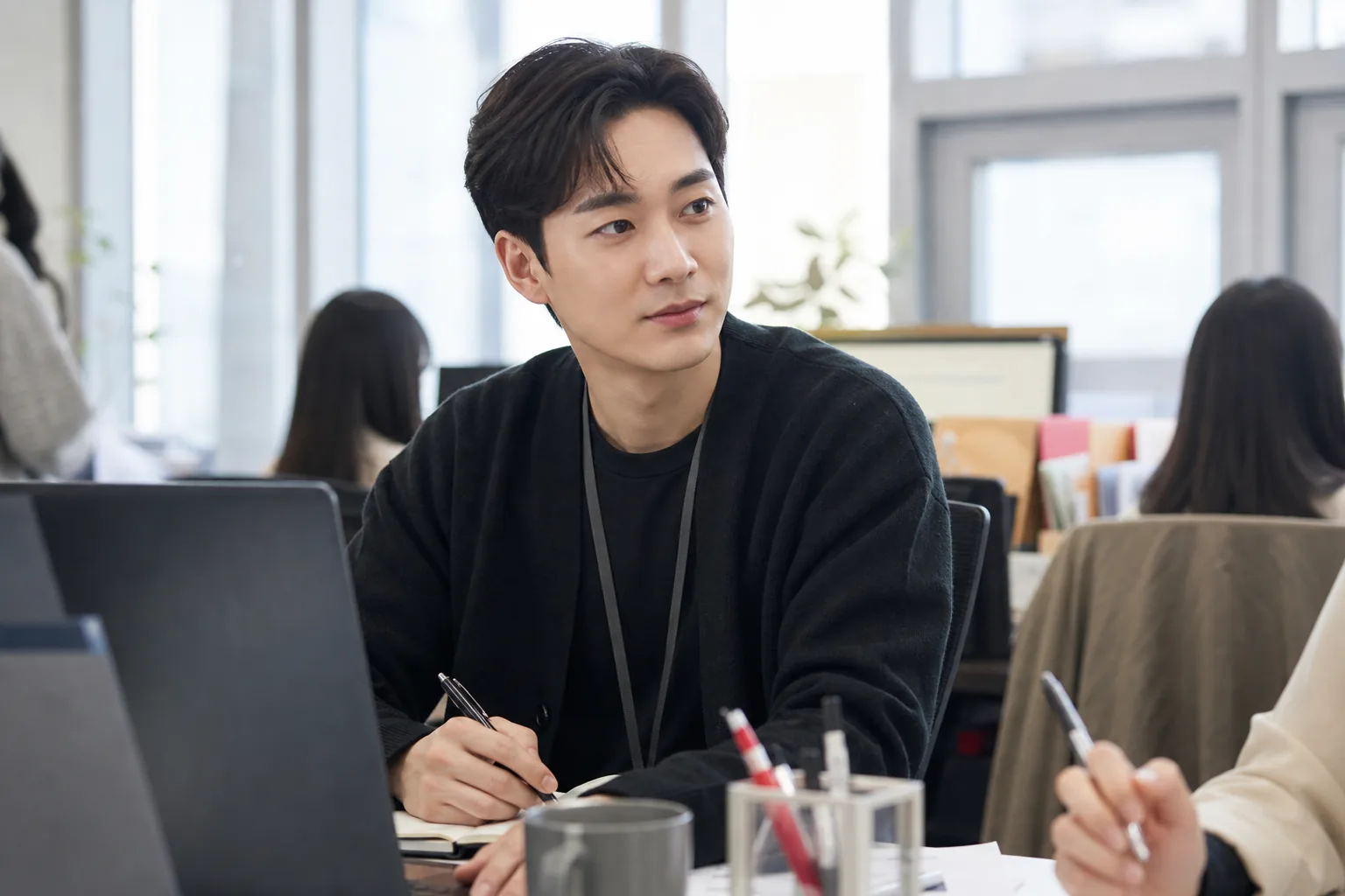 Marketing office desk representing Aron balancing idol activities and corporate work