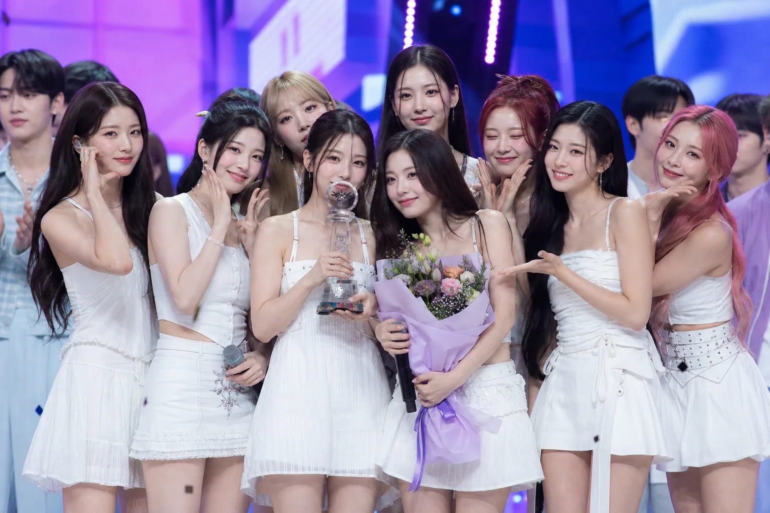K-pop music show stage with multiple comeback performers