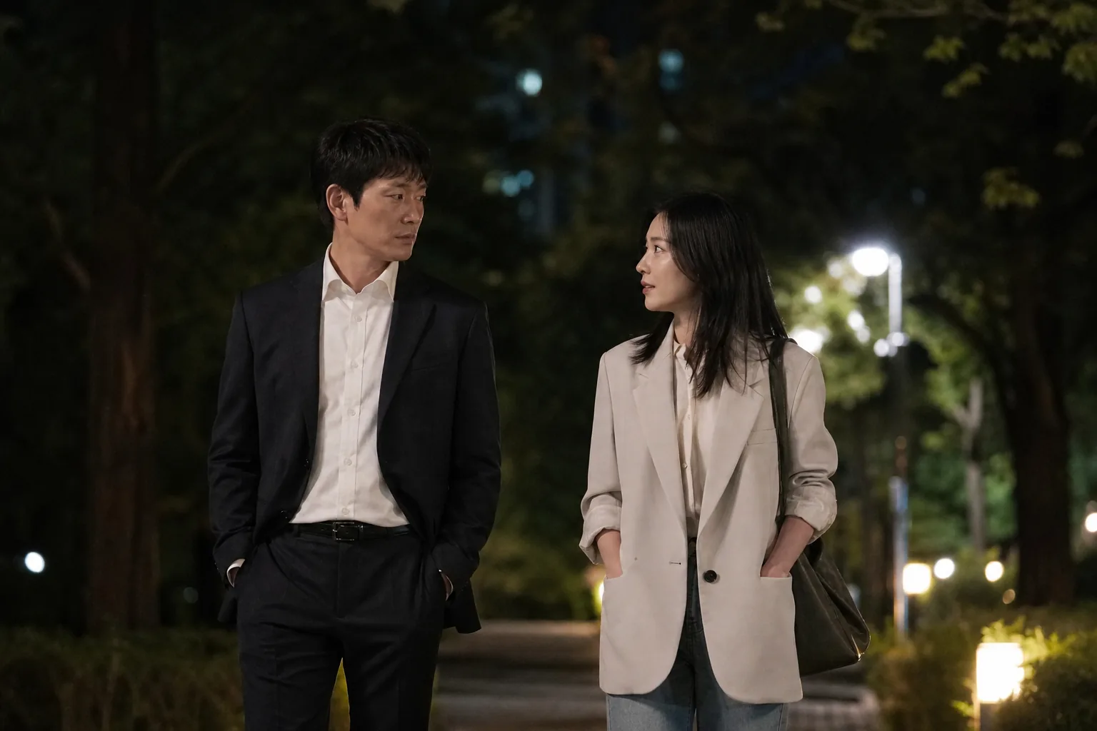 Korean drama-style nighttime walk between two people in conversation