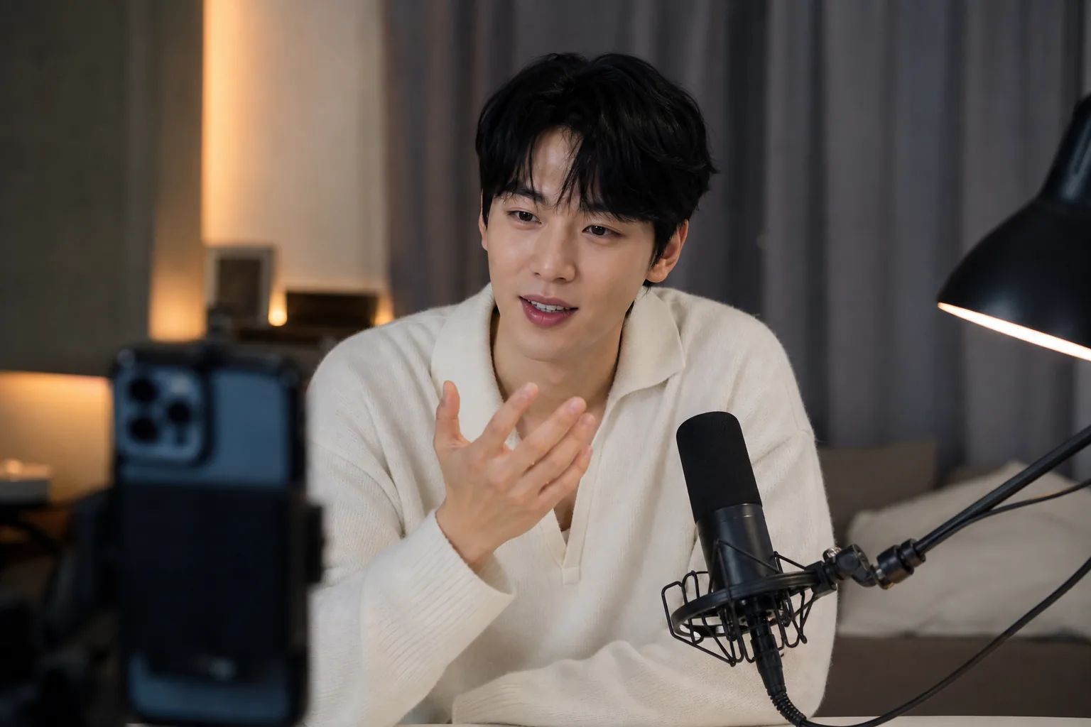 Editorial visual of a live content creator speaking to viewers in a modern streaming studio