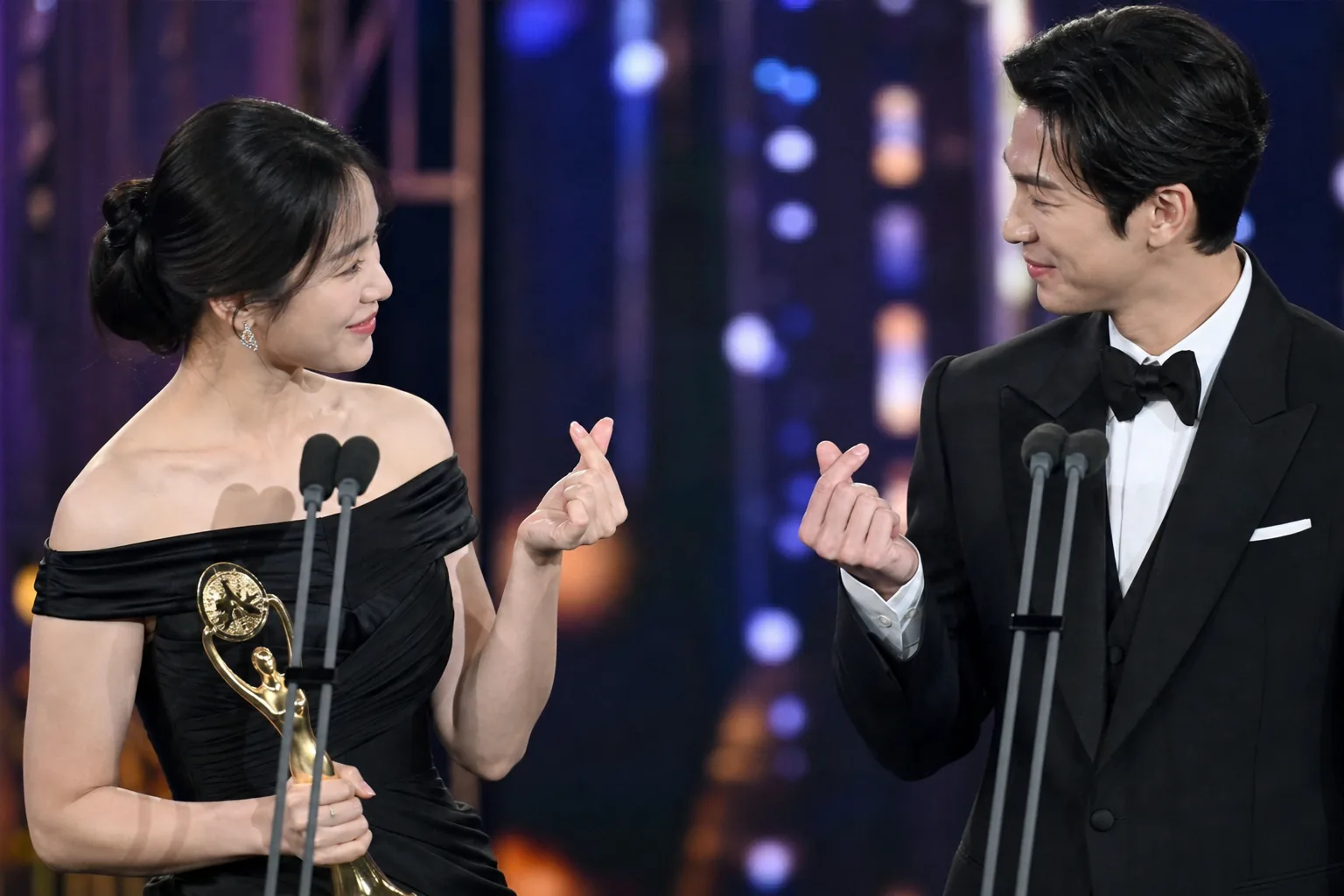 Award winner acknowledging fellow cast members from a theater stage