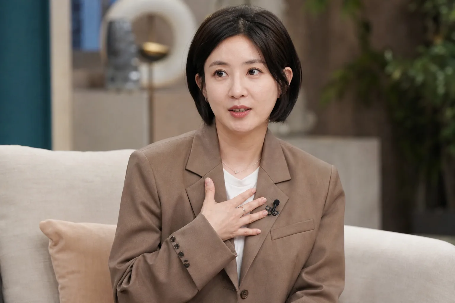 Thoughtful Korean entertainment discussion in a bright studio