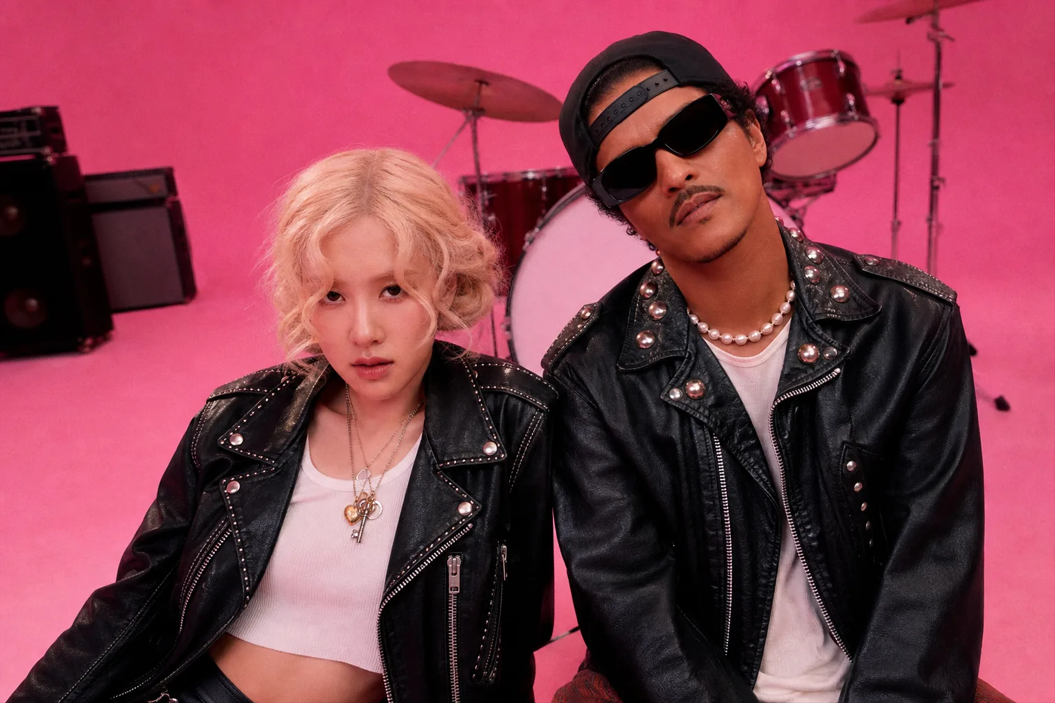 Editorial image of a pop music collaboration in a brightly lit recording studio